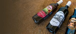 Three bottles of our wines: a Sangria, a Zinfandel, and a chocolate caramel dessert wine