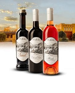 Three bottles of wine including a dessert wine, red wine, and rose wine