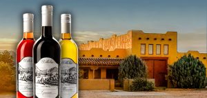 Three bottles of wine in front of our Sonoita winery, vineyard, and tasting room